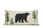 This decorative pillow features a black bear and trees.
