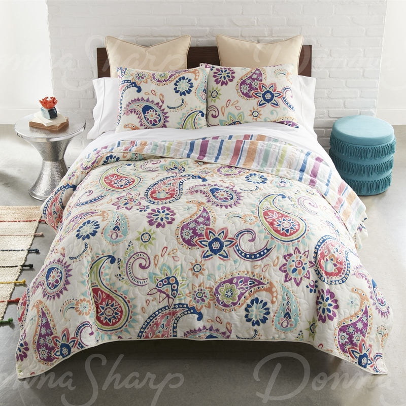 This colorful quilt has large painted paisley and floral motifs.