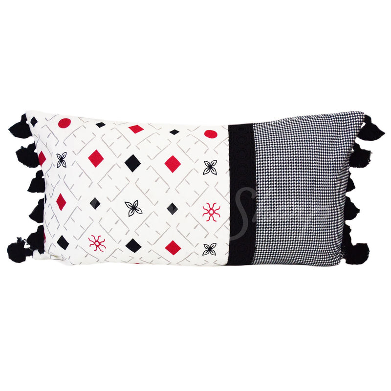 The back of this pillow has a fun design in red, black, and grey with tassels on each end.